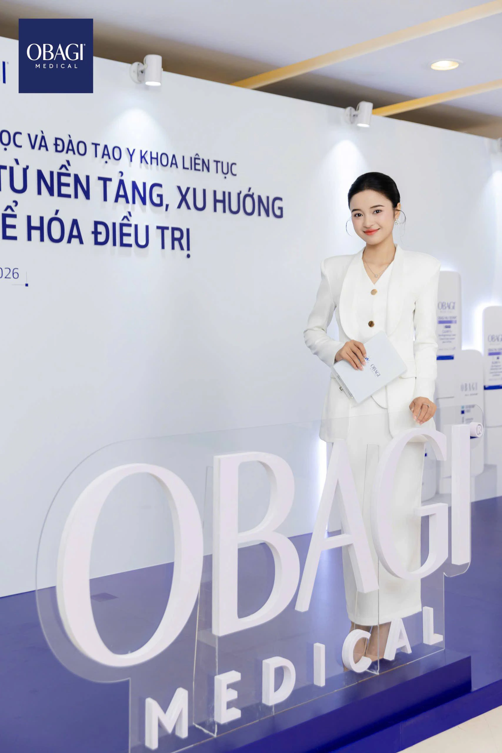 Nga Lyna at the Obagi Medical scientific conference backdrop
